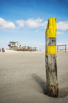 Look at the building of the sandy beach of St. Peter-Ording at the North Sea in Germany on a sunny day in spring