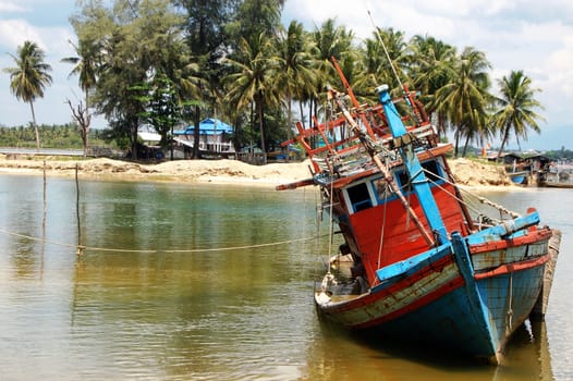 Abandoned sinked ship at town port, South Thailand