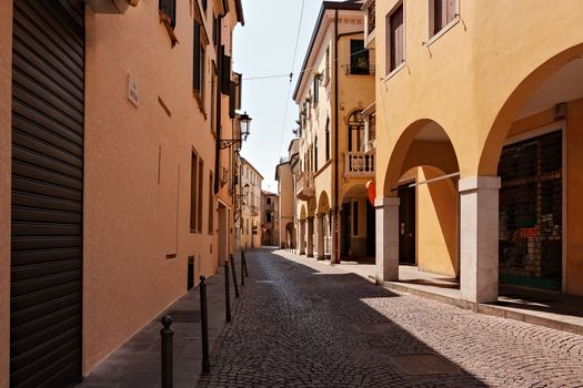 Corner of yellow building with street light on piazza Capitaniato in Padua Italy