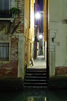 Venetian alley in the darkness . Italy