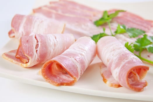 Tasty sliced bacon with vegetables isolated on white background