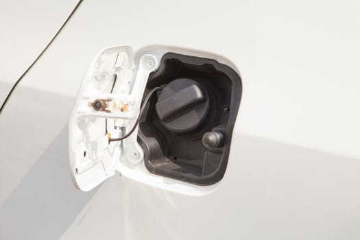 Closeup refuel gasoline on white car