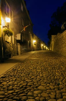 Illuminated street in old part of Tallinn by night