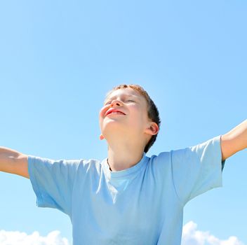 happy boy on the blue sky background