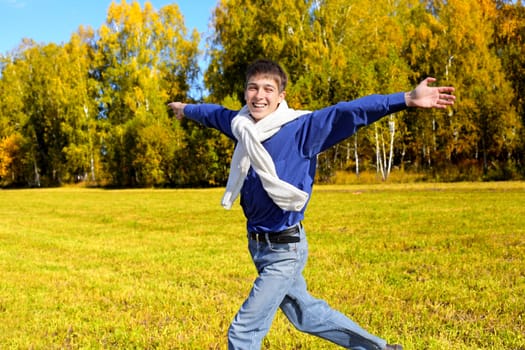 happy teenager running in the autumn forest