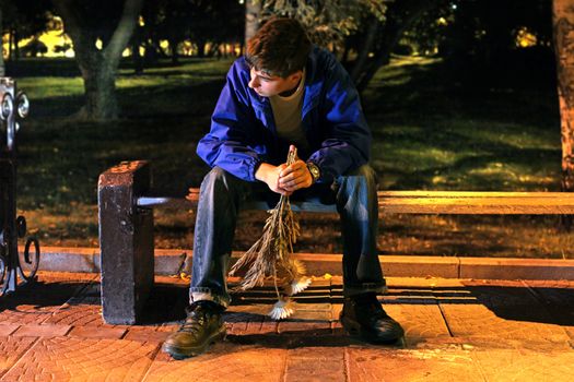 teenager in the night park with a flowers get break an appointment