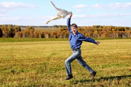 happy teenager running on the autumn field