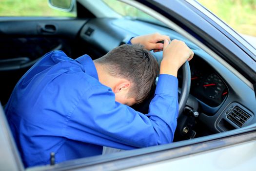 young man fall asleep in a car