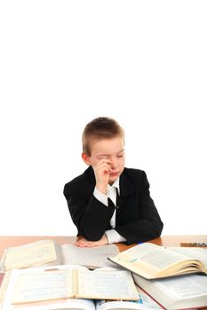 very sad schoolboy crying on the table isolated on the white background