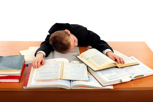 tired schoolboy lying and sleeping on the books