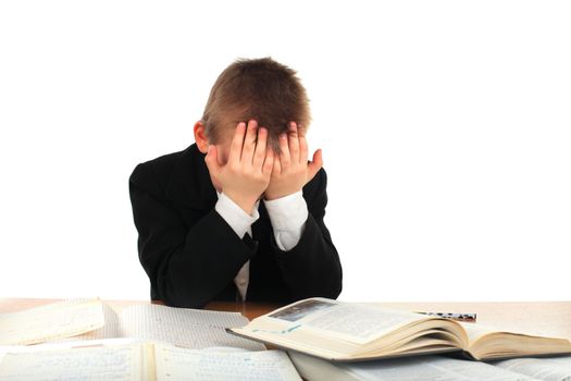 tired schoolboy on the table isolated on the white background