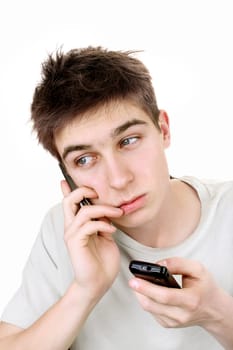 sad young man looking on the mobile phone. isolated on the white