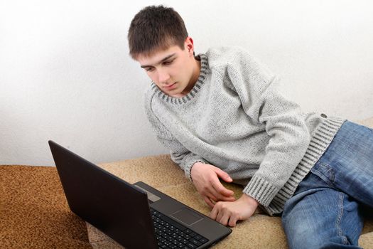 young man with notebook on sofa