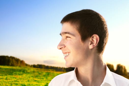 happy young man portrait in the summer field