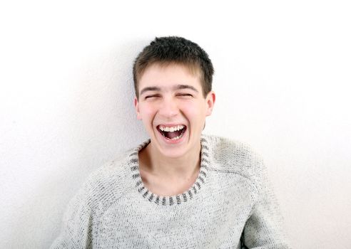 happy teenager laughing on the white background