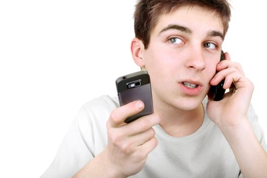 busy young man talking with two mobile phones on the white background