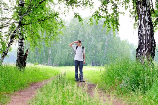 teenager with knapsack get lost in summer forest