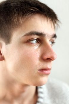 sad and tearful young man portrait closeup