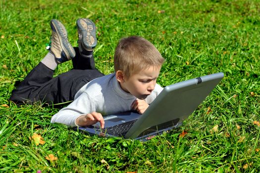 boy with notebook on the summer meadow