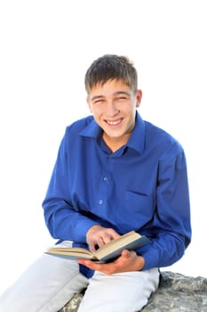 happy teenager sitting with a book on the stone. isolated on the white