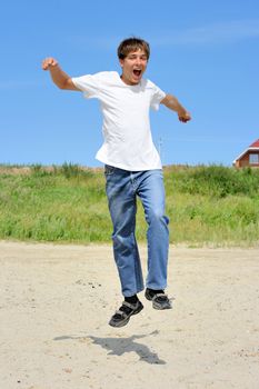 happy teenager running on the beach