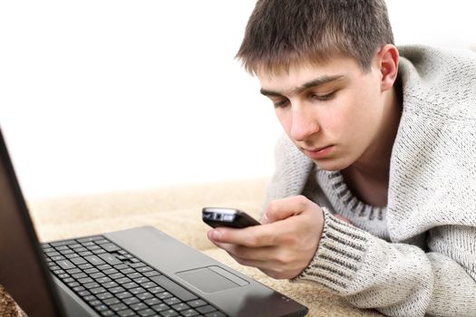 teenager with notebook and mobile phone in home interior