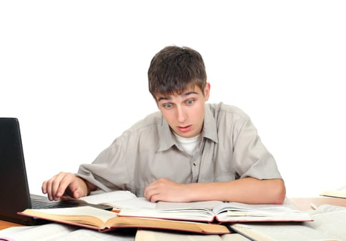 amazed young male student working with many books on the table