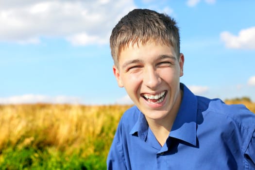 happy and smiling teenager portrait in the field