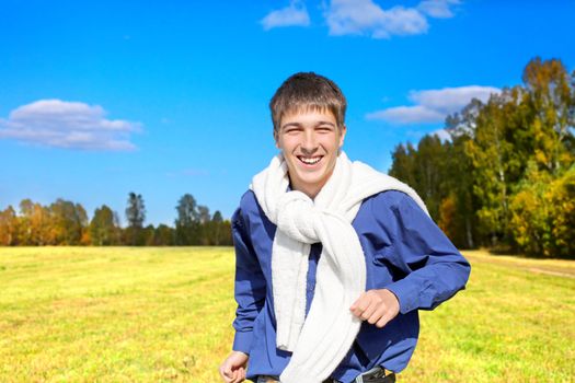 happy teenager running on the autumn field