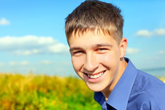 happy and smiling teenager portrait in the field