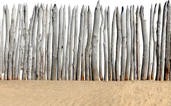 old wooden fence on the sand isolated on the white background