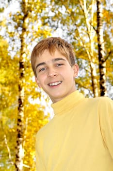 teenage boy portrait in the autumn park