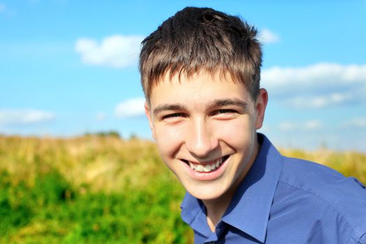 happy and smiling teenager portrait in the field