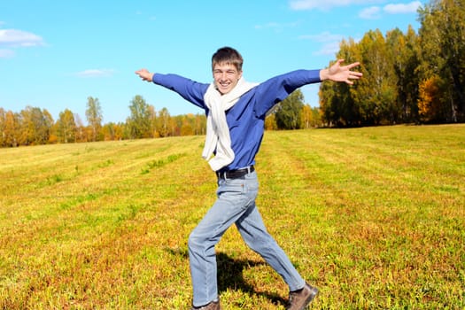 happy teenager running on the autumn field