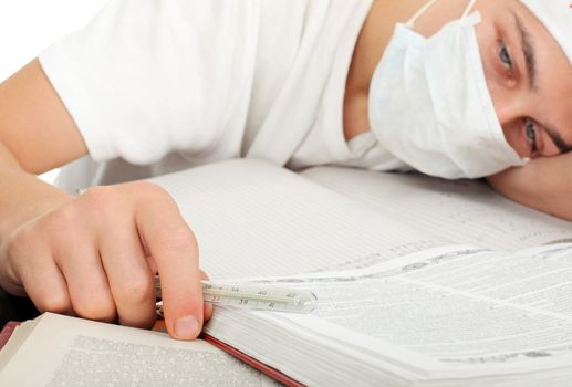 diseased young man in flu mask lying on the table closeup