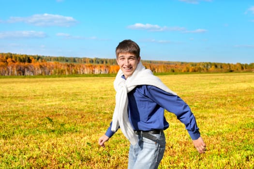 happy teenager running in the autumn field