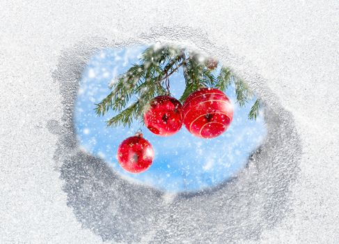 christmas decorations view through the thawed hole in the window