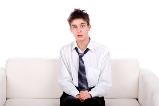 Amazed Teenager on the Sofa isolated on the White background