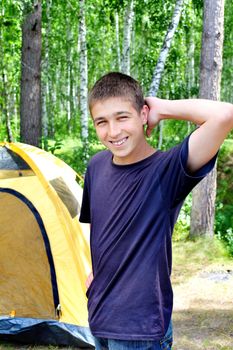 Happy young Man camping in the forest