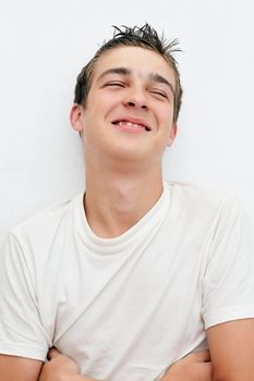 Satisfied Young Man on the White Wall background