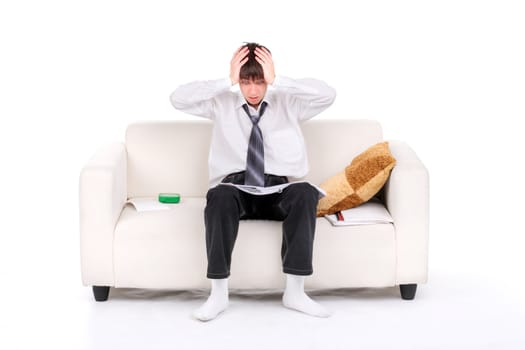 Shocked Teenager reads the book on the Sofa. Isolated on the white