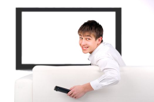 Cheerful Teenager sitting on the Sofa and watching Tv-set