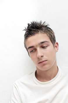 Sad Young Man portrait on the White Wall background