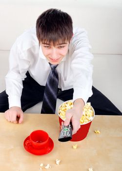 Happy Teenager with Remote Control and Popcorn