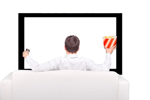 Teenager with Remote Control and Popcorn sitting on the Sofa and watching Tv-set