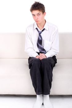 Shy Teenager on the Sofa isolated on the White background