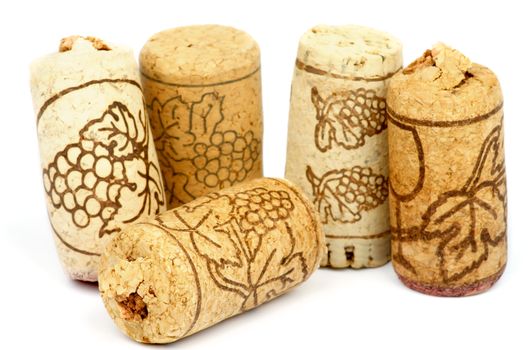 Five Old Wine Corks with Grape Symbols isolated on white background