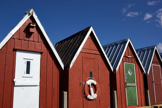 Beautiful red fishing huts on the coast Faaborg Denmark