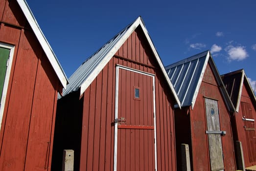 Beautiful red fishing huts on the coast Faaborg Denmark