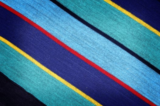 Fabric texture with diagonal color stripes. Close up